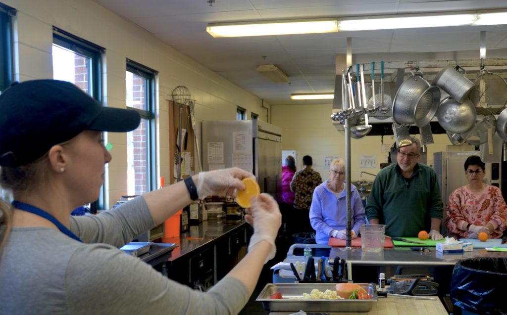 Chef showing the class an orange slice