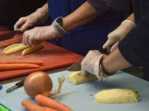 culinary students cutting carrots