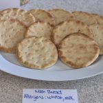 Circular Pieces of Bread overlapping on a white dish